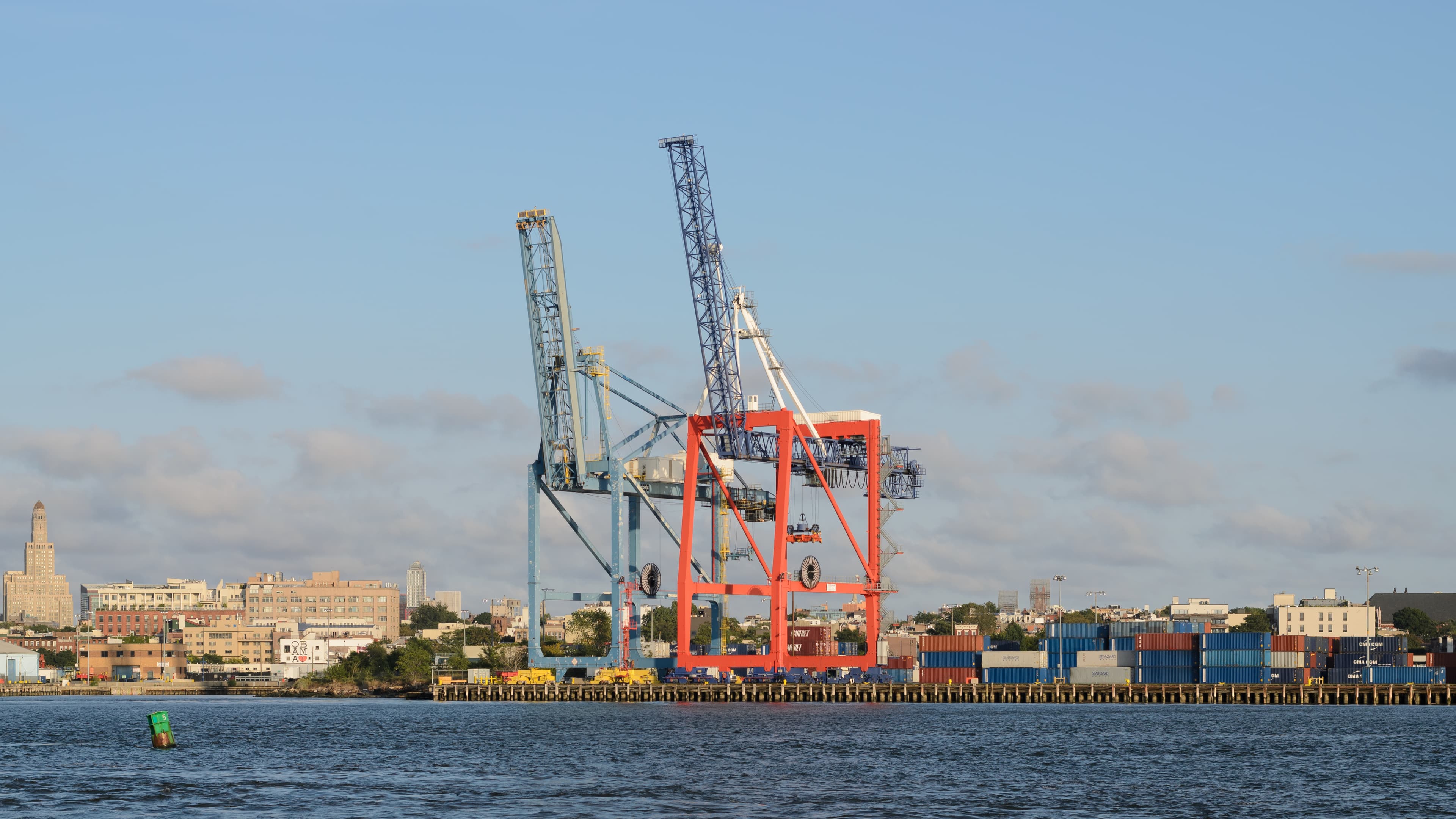 Container terminal with ship-to-shore cranes and stacked cans